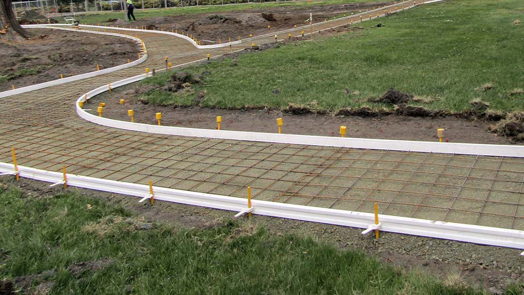 Construction of a curved pathway in a park with Con-Form formwork setup.